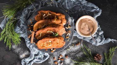 Traditional Christmas Rabanadas with lemon zest, raisins, pine nuts and cinnamon. Spanish Torrijas or french toasts close up on the countertop