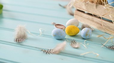 Easter blue and white eggs in wooden box and white tulips. clipart