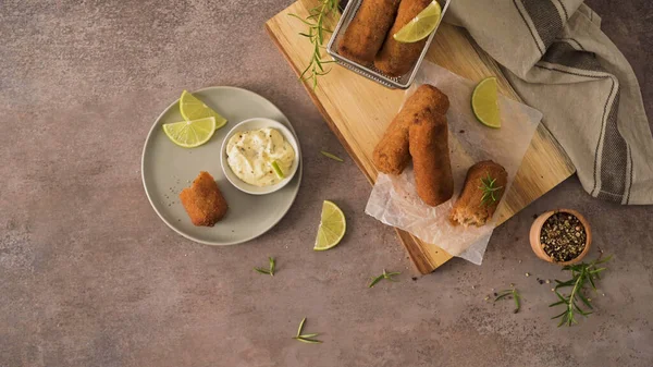 Meat Croquets Rosemary Leaves Lemons Wooden Cutting Board Kitchen Counter — 스톡 사진