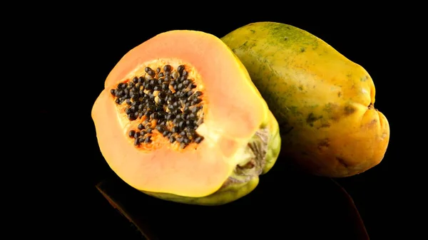 stock image Fresh and tasty papaya on black background.