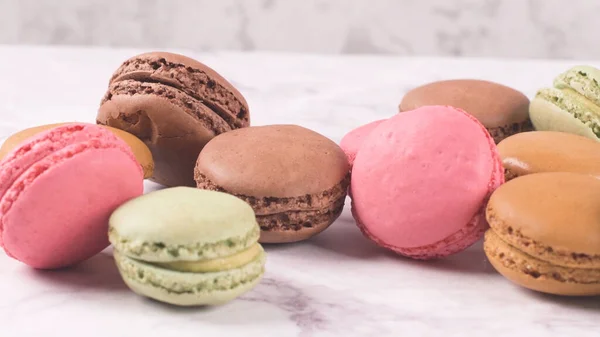 stock image Macarons macaroons cookies dessert from France isolated on a white marble countertop.