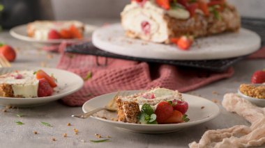 Meringue roll cake with cream, raspberries. Roulade, summer dessert served in ceramic plate.