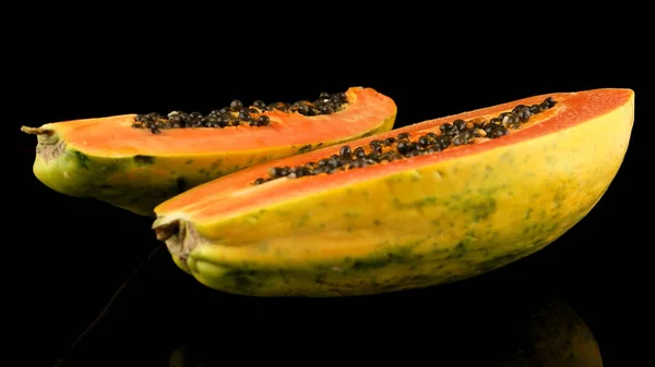 Fresh and tasty papaya on black background.