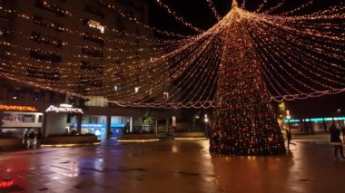 Sao Joao da Madeira, Portekiz - 30 Kasım 2023: Bir yürüyüşçünün Noel ışıklarıyla süslenmiş şehir sokaklarına bakış açısı. Perlim tema parkındaki dekorasyon aynı kalıyor..