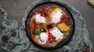 Bolo Rei or Kings Cake is a traditional Xmas cake with fruits raisins nut and icing on kitcthen countertop. Is made for Christmas, Carnavale or Mardi Gras