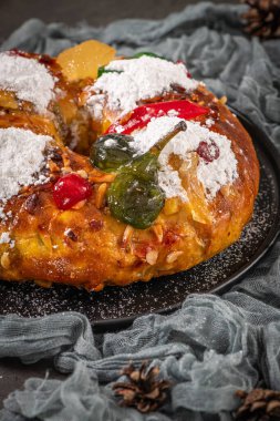 Bolo Rei or Kings Cake is a traditional Xmas cake with fruits raisins nut and icing on kitcthen countertop. Is made for Christmas, Carnavale or Mardi Gras