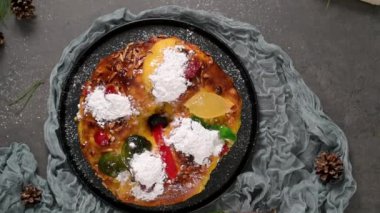 Bolo Rei or Kings Cake is a traditional Xmas cake with fruits raisins nut and icing on kitcthen countertop. Is made for Christmas, Carnavale or Mardi Gras
