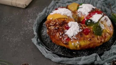 Bolo Rei or Kings Cake is a traditional Xmas cake with fruits raisins nut and icing on kitcthen countertop. Is made for Christmas, Carnavale or Mardi Gras