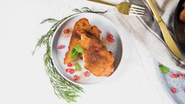 Traditional Christmas Rabanadas with pommegranate seeds, pine nuts and cinnamon. Spanish Torrijas or french toasts close up on the countertop.
