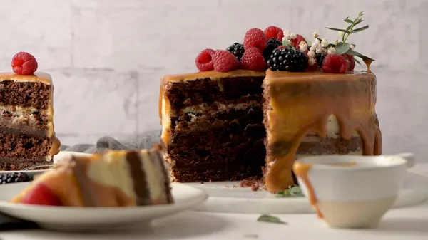 블랙베리와 라즈베리를 곁들인 맛있는 캐러멜 케이크 스톡 사진