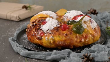 Bolo Rei or Kings Cake is a traditional Xmas cake with fruits raisins nut and icing on kitcthen countertop. Is made for Christmas, Carnavale or Mardi Gras