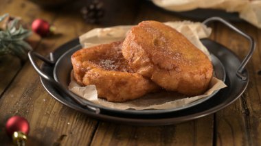 Traditional Portuguese Christmas Rabanadas. Spanish Torrijas on kitchen countertop. clipart