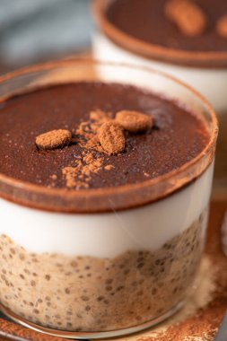 Delight in a luscious tiramisu-inspired chia pudding, layered with creamy coffee-infused chia and a rich chocolate topping. This guilt-free breakfast or dessert option blends classic flavors with wholesome ingredients for a convenient and satisfying  clipart