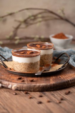 Savor a delectable tiramisu-inspired chia pudding, featuring layers of creamy coffee-infused chia and a decadent chocolate topping. This guilt-free breakfast or dessert blends classic flavors with wholesome ingredients for a convenient and satisfying clipart