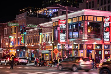 Nashville, Tennesee - January 21, 2023:  Street scene from famous lower Broadway in Nashville Tennessee viewed at night with lights, historic honky-tonks, bars and restaurants. 