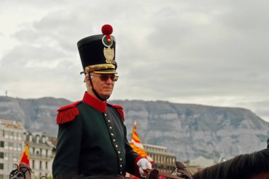 GENEVA; SWITZERLAND-May 04, 2024: Cavalry officer in the uniform of the militia of the Vaud canton in shako with pompom. Old Grenadiers March, 275-years anniversary of the Vieux Grenadiers society, May 04, 2024 clipart