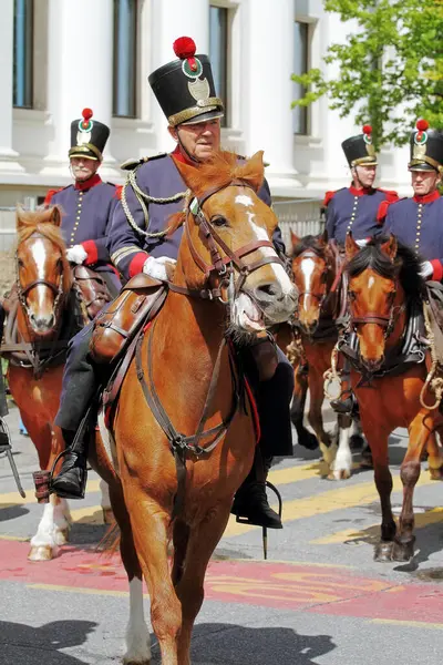 stock image GENEVA; SWITZERLAND-May 04, 2024: Cavalry squad in the uniform of the militia of the Vaud canton. Old Grenadiers March, 275-years anniversary of the Vieux Grenadiers society, May 04, 2024