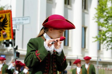 GENEVA; SWITZERLAND-May 04, 2024: Young flutist, Geneva fifes and drums Orchestra member, takes part in a street parade. Old Grenadiers March, 275-years anniversary of the Vieux Grenadiers society, May 04, 2024 clipart