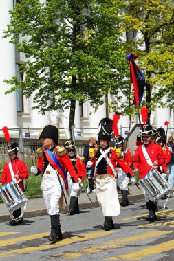 GENEVA; SWITZERLAND-May 04, 2024: Historical Militia of Leontica officer with saber leads a infantry squad. Old Grenadiers March, Vieux Grenadiers society 275-years anniversary, May 04, 2024 clipart