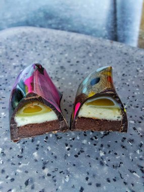 Handmade chocolate bonbons in colorful glaze with assorted fillings  unwrapped artisan sweets