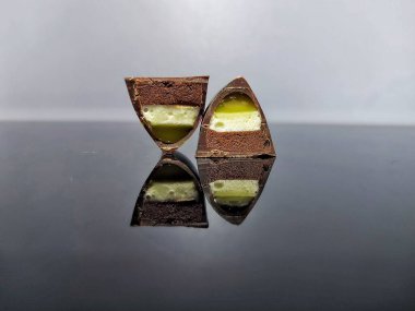 Handmade chocolate bonbons in colorful glaze with assorted fillings  unwrapped artisan sweets