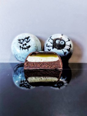 Handmade chocolate bonbons in colorful glaze with assorted fillings  unwrapped artisan sweets