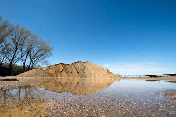 Pile Sand Its Reflection Water Stock Picture