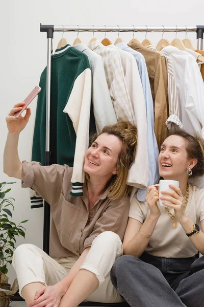 Концепция Организации Гардероба Две Подруги Делают Селфи Возле Стойки Одежды — стоковое фото