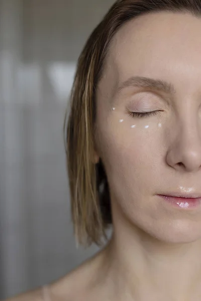 Eye skin care female wellness routine. Close up portrait of woman.