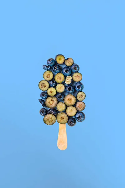 Blueberry popsicle with stick. Summer creative concept.