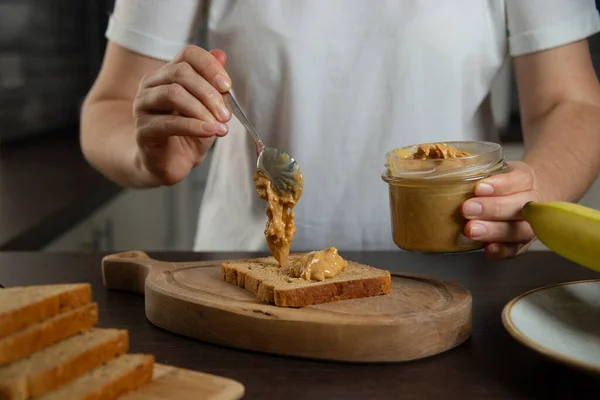 stock image Peanut butter - woman preparing breakfast.