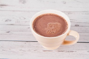 Cup of hot chocolate on a wooden background
