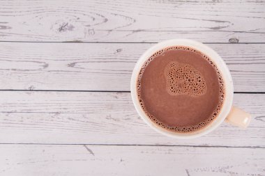 Cup of hot chocolate on a wooden background