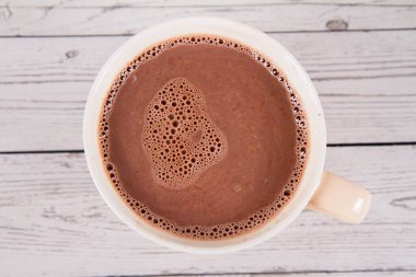 Cup of hot chocolate on a wooden background