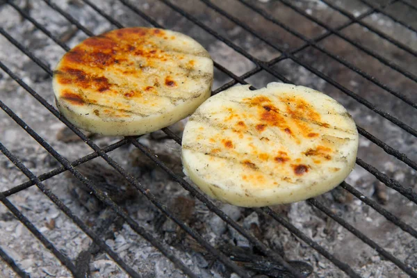 Cheese being grilled in a garden