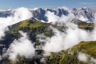 Dolomites mountains in the middle of Clouds, Carnian Alps mountains, Italy
