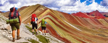 Rainbow mountains or Vinicunca Montana de Siete Colores with three tourists or hikers, Cuzco region in Peru, Peruvian Andes clipart