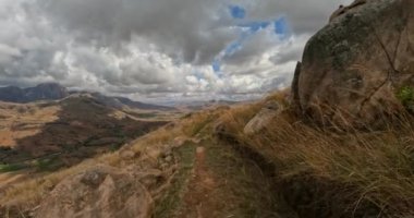 Hiking Andringitra national park, Madagascar, mountain landscape, descent trail from high peak. Walking tourist trail in Andringitra mountains. Madagascar wilderness landscape.