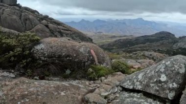 Hiking Andringitra national park, Madagascar, mountain landscape, descent trail from high peak. Walking tourist trail in Andringitra mountains. Madagascar wilderness landscape.