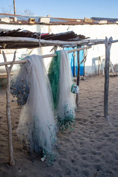 Traditional fisherman's net hangs in the warm sunshine on the beach of Anakao village in Madagascar. Fishing is an important part of the local economy.