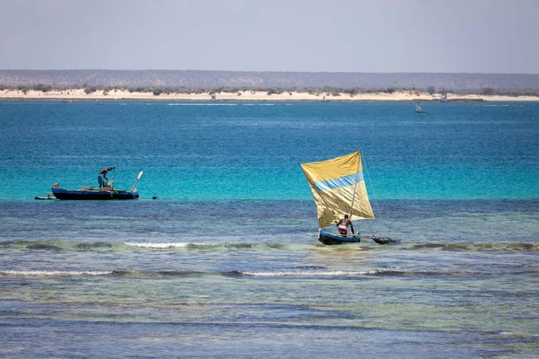 Beautiful scenery of a colorful fishing boat and fisherman sailing on a calm sea under the warm sun of Nosy Ve, Anakao, Toliara, Madagascar
