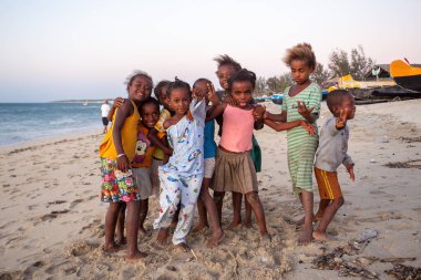 Anakao, Madagascar - November 21. 2022 - Group of Malagasy children frolicking on the beach near the fishing village of Anakao.
