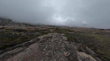 Hiking Andringitra national park, Madagascar, mountain landscape, descent trail from high peak. Walking tourist trail in Andringitra mountains. Madagascar wilderness landscape.