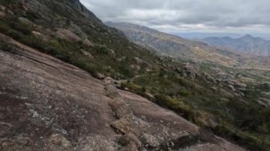 Hiking Andringitra national park, Madagascar, mountain landscape, descent trail from high peak. Walking tourist trail in Andringitra mountains. Madagascar wilderness landscape.