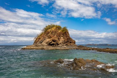 Playa Ocotal with Pacific ocean waves on rocky shore, El Coco Costa Rica. Famous snorkel beach. Picturesque paradise tropical landscape. Pura Vida concept, travel to exotic tropical country. clipart