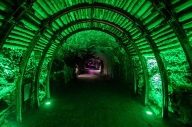 Entry tunnel to subterranean cathedral glows with spiritual light in the underground Catedral de Sal (Salt Cathedral) of Zipaquira, Colombia. clipart