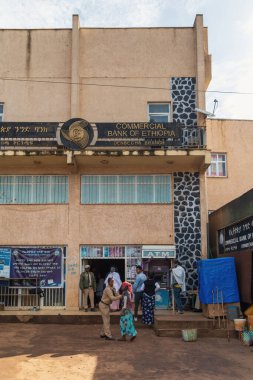 Dembecha, Ethiopia - April 20 2019: Local citizens gather at the entrance of the Dembecha branch of the Commercial Bank of Ethiopia.