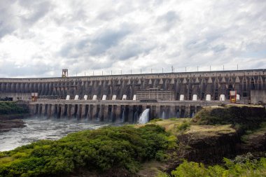 Itaipu Binacional, Brazil - June 22 2025: The base of the dam structure, highlighting the scale of the power plant and the adjacent water channel.