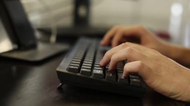 Bir programcının elleri hızla mekanik bir klavyeye basıyor. Profesyonel ortam, bulanıklık ile yakın çekim.
