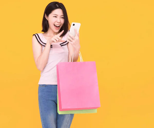 Mujer Joven Feliz Mirando Teléfono Móvil Sosteniendo Bolsas Compras —  Fotos de Stock